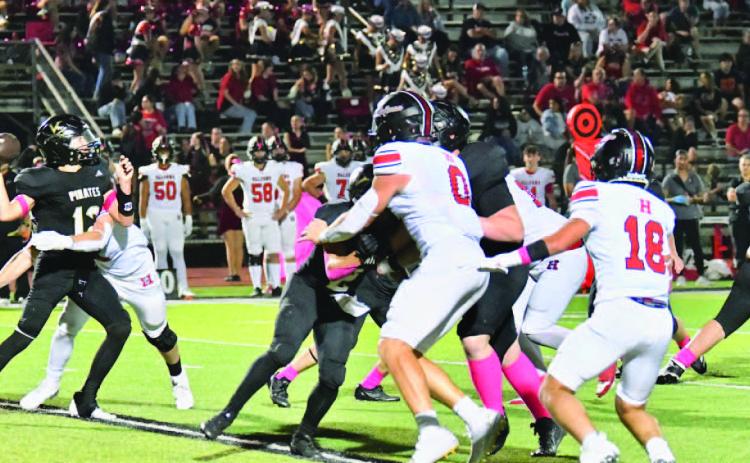 Under pressure Jett Brucia gets a pass off as a Falcon defender makes contact.