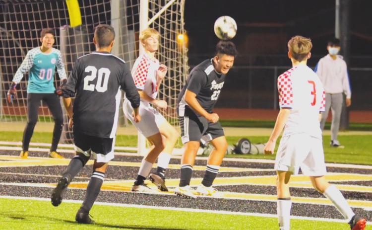 Varsity Pirates Aaron Guevara, #23 and Fidel Nava #20 work the ball at the Raider goal following a corner kick