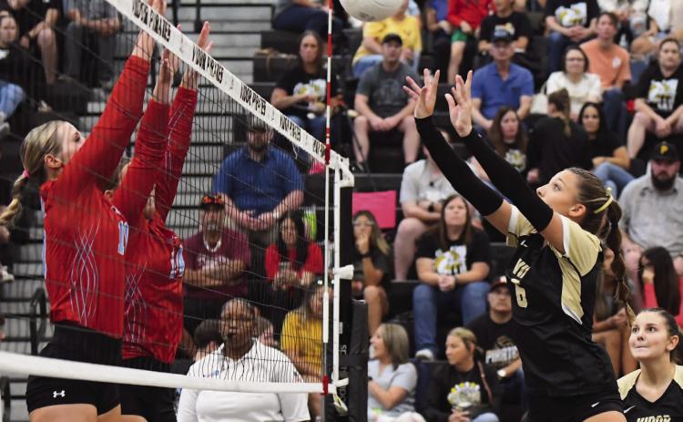 Lady Pirate Paislee Miller returns the ball in Friday night’s loss to Lumberton.