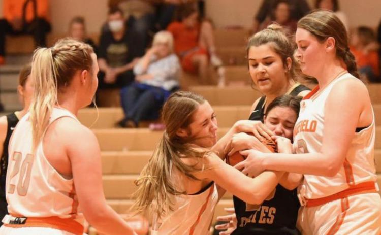 Lady Pirate Sofia Rodriguez is caught between two Lady Bobcats as she fights for control of the ball.