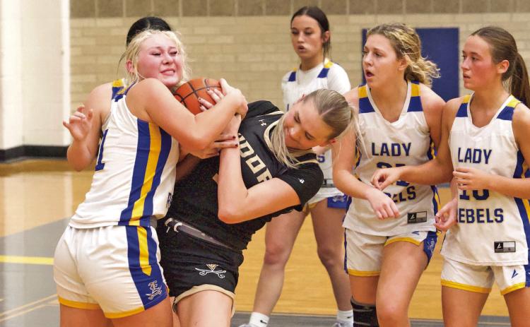 Battle for possession Vidor’s Raegan Stephenson battles with an Evadale Lady Rebel for possession of the ball during Tuesday night’s varsity game in Evadale. The Lady Pirates begin district play Friday in Lumberton.