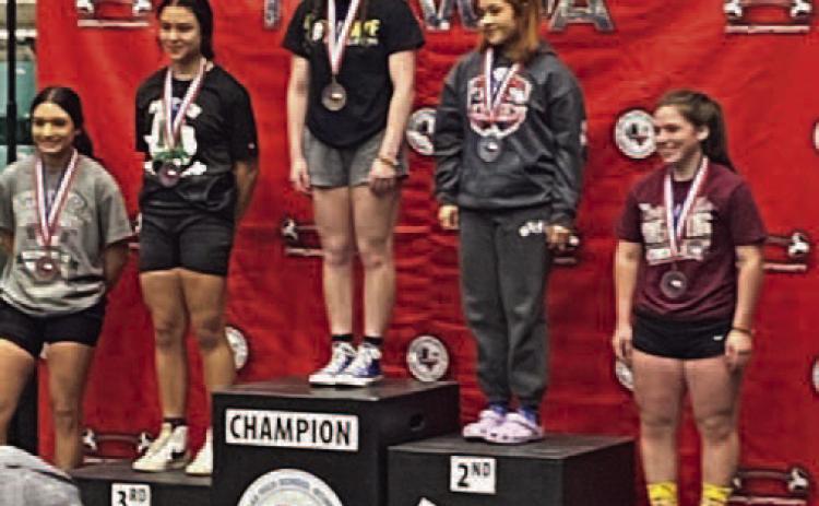 Camryn Barragan, center, set a new state record with a 250 pound lift in bench press in the 123 weight class at the Girls State Powerlifting Meet last week. the previous record was 215 pounds. Vidor’s team placed 4th at the state meet. Photo by Randall Luker