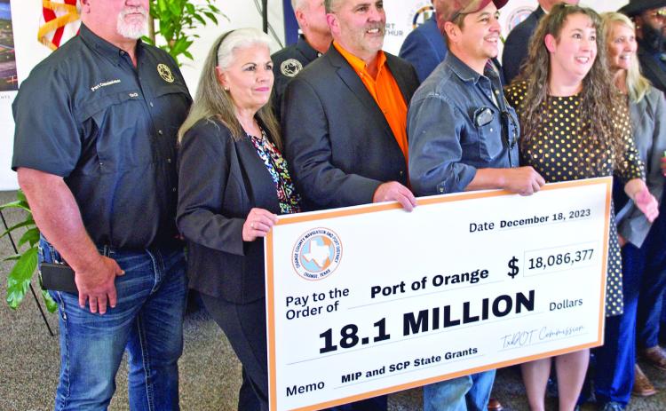 Port of Orange officials hold a facsimile check representing the historic $18.1 million in state funding that will repair and improve port facilities. Southeast Texas ports will share in a total of $66 million in state grant funding to improve port infrastructure.