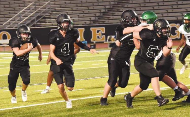 JV RB Caleb Dean bursts out of the backfield as #4 Ricky Gall, #50 Brooklyn Freeman, and #51 Jesse Meyers get out front to block.