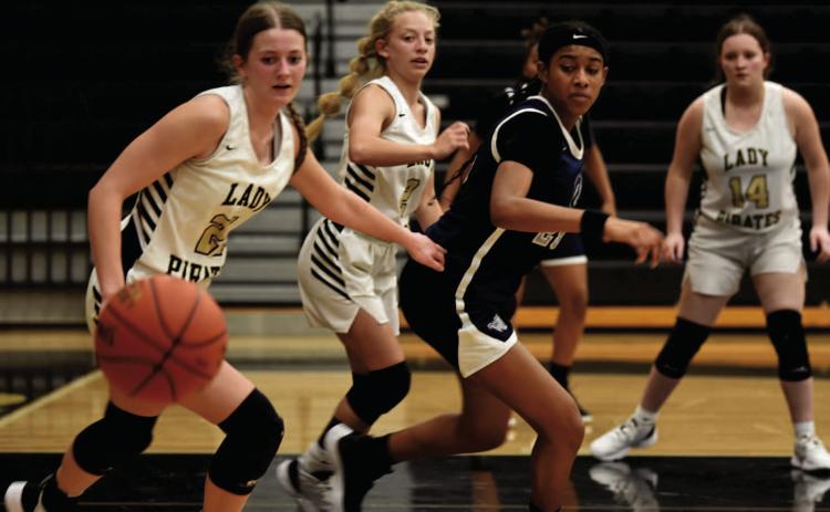 Madison Powell, Mia Robin and Carlie Abbott, left to right, keep an eye on an up for grabs ball lat week’s district matchup with The lady Mustangs of West Orange Stark. Photo by Randall Luker