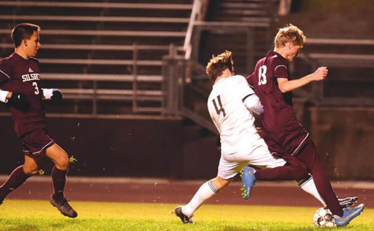 Alex Ramos battles a Silsbee Tiger for possession. Photo by Randall Luker