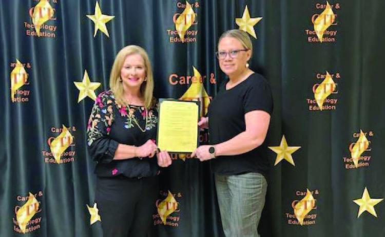 Pictured is Mayor Misty Hart presenting CTE Director Penny Singleton with a signed Proclamation Document