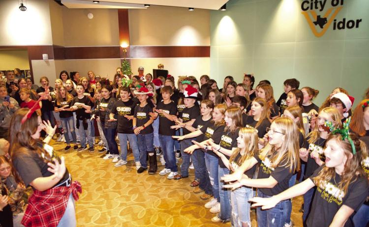 The Vidor Middle School 6th Grade Choir under the direction of Genevieve Brassard entertained a crowd Friday at Vidor City Hall at the Light Up City Hall portion of the 3-day Vidor Hometown Holidays event sponsored by the City of Vidor, Vidor Chamber of Commerce and Eastgate Church.