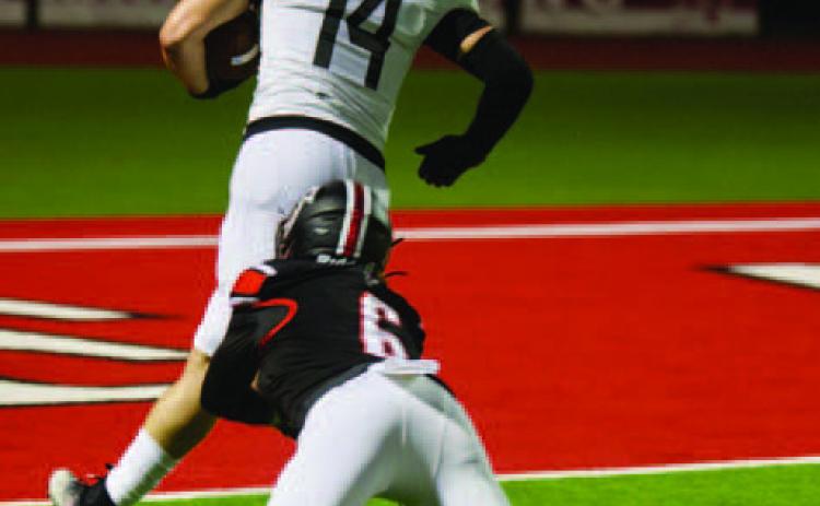 Pirate running back Jason Watson, #14, scores his first of six rushing touchdowns against Huffman Friday. The Huffman player is Tyler Wilkins, who scored five catches for touchdowns for the Falcons. Photos by Randall Luker