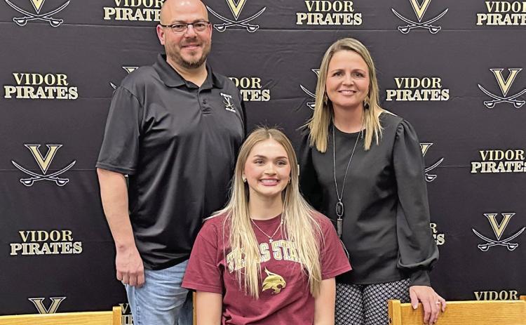 Lady Pirate high jumper Raegan Stephenson officially committed to Texas State in San Marcos last week. As a Freshman, Stephenson won a silver medal in the 4A girls high jump at the state meet and last year, she won the gold medal with a jump of 5 feet, seven inches. Stephenson is pictured with her coaches Darin Fletcher and Tracy Maines.