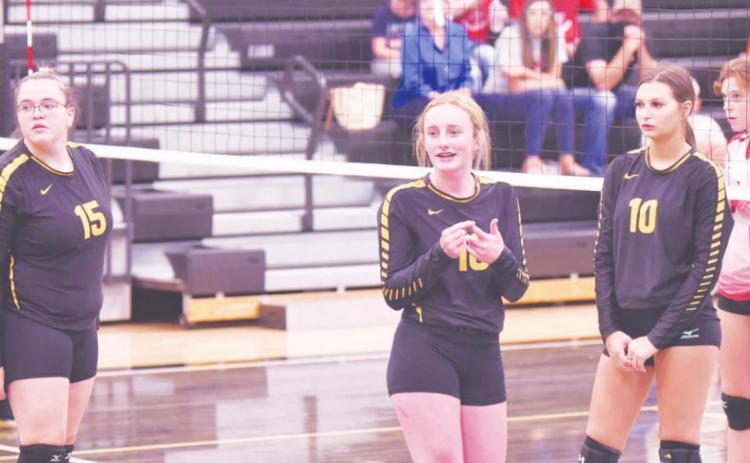 Lady Pirate junior varsity players 15-Ashlee Malagarie, 16-Natalie Morrison and 10-Andreya Garrett look to the sidelines during a break in the action Friday night versus Deweyville.