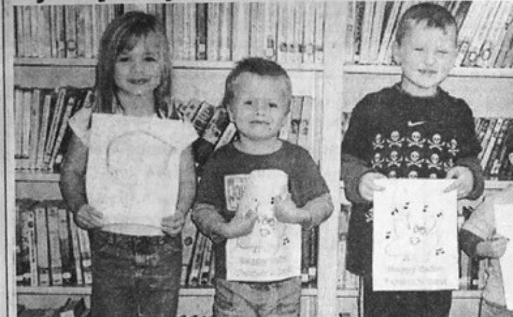 Vidor Public Library's Itty Bitty story time was held on Thursday, March 6. Assistant Director, Colette Turner read 'Library Lil' by Suzanne Williams to the children. Pictured are Kaylie Trinkle, Jeremy Trinkle, Leven Barney and Jeffery Livingston with their books they made. Archive Photos