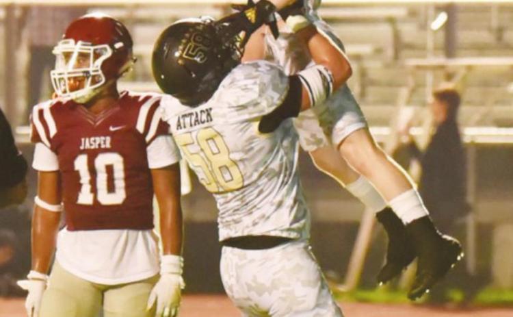 Caiden Veazey hoists Weston Sepulvado into the air after he scored a second half touchdown.