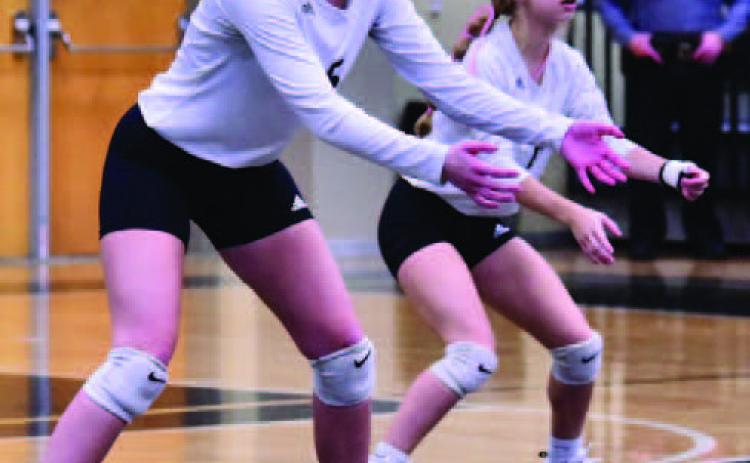 Varsity Lady Pirates Madison Powell, left, and Mia Robin await a Silsbee Lady Tiger serve Friday. Photo by Randall Luker