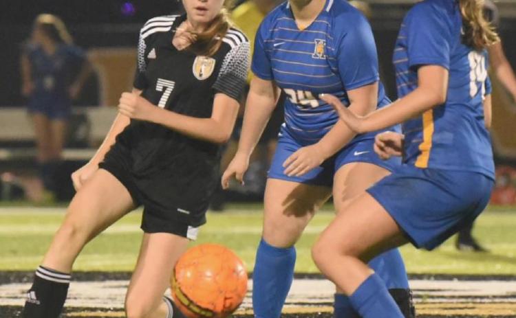 Freshman Lady Pirate Chloe Post looks to pass the ball to an open teammate. Photo by Randall Luker
