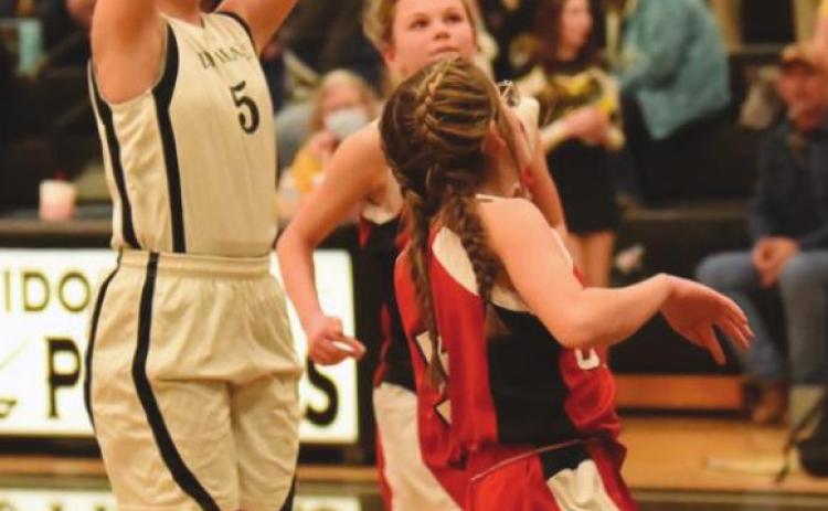 Lady Pirate Cassidy Callarman takes a shot over two Bridge City defenders in the 8B game.