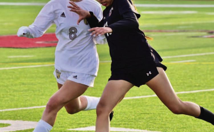 Natalie Domec closes in on a Jasper player in Friday’s away game at Jasper. Photo by Randall Luker