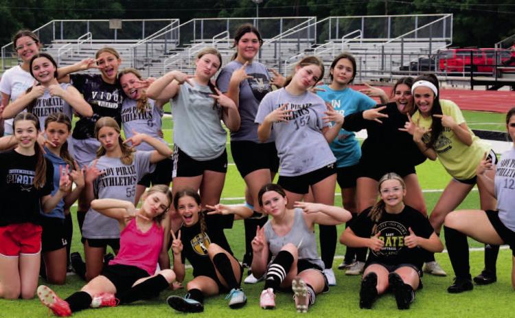 Vidor’s 8th grade Lady Pirate soccer team mugs for the camera after practice this week. This marks the first year for the 7th and 8th grade junior high girls soccer program at VISD. After a rainout last week, both teams will play their first game Thursday versus Central at Pirate Stadium with the 7th grade team at 5:30 and 8th grade at 6:50 p.m. Photo by Randall Luker