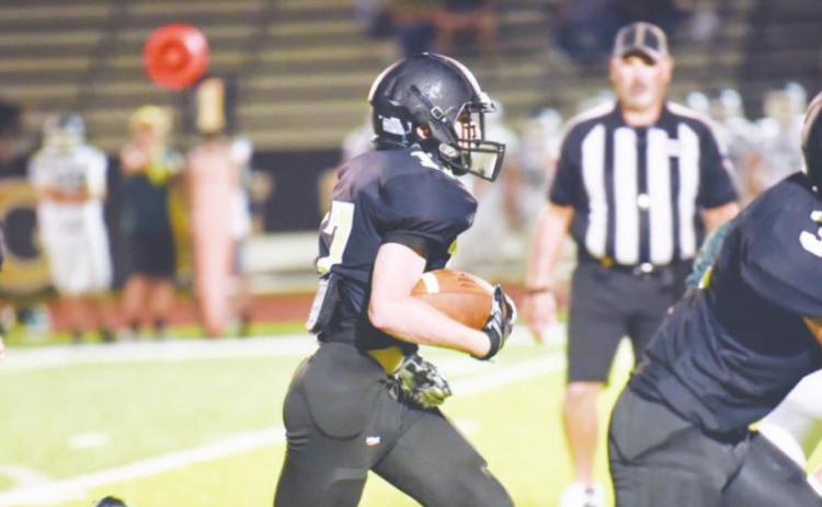 Grant McWherter, center, picks up a first down and more as #3, Jaecob Titman and #25 Trent Korman run interference. Photo by Randall Luker