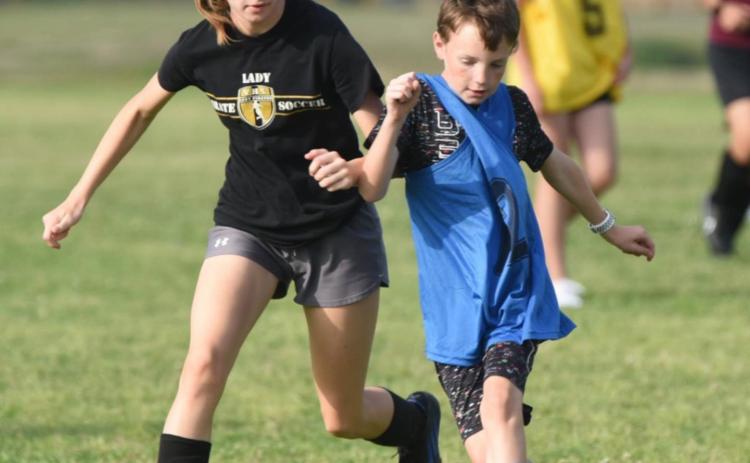 Vidor Junior High plans to field both boys and girls 7th and 8th grade soccer teams in the fall of 2022 competing against a number of other district schools. These youths are practicing at the junior high as part of an intramural league playing many of those same future district opponents. This is the second year for the local teams to play. Volunteer coaches lead the practices as they teach fundamentals of the game in prepartion for the VISD to join UIL play next school year. Photo by Randall Luker