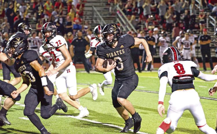 Pirate running back Isaac Fontnow runs left for a first down Friday against the Huffman Falcons.