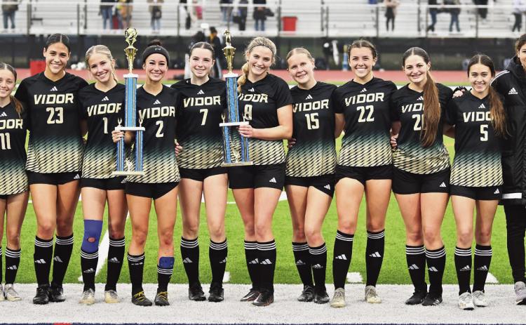 The Vidor Lady Pirates are all smiles as they pose with their two trophies for winning the HJ soccer tournament and scoring the most goals.