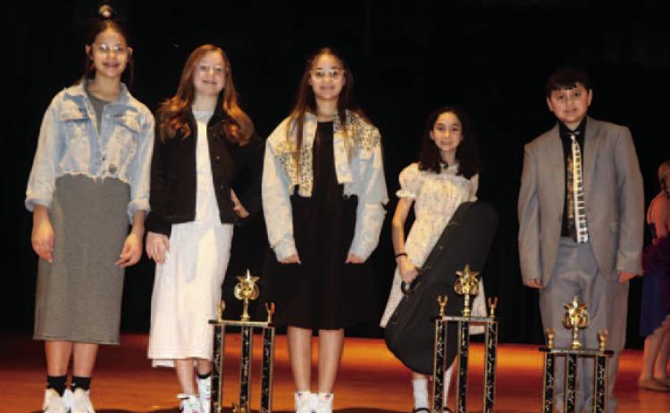 Junior competition winners from left to right: Brylee Lofting, Brynna Loftin and Kortlyn Hennessy won 2nd place for their vocal trio, Hope Nielson won first place for her vocal/instrumental, and William Nele took 3rd place for his piano solo.