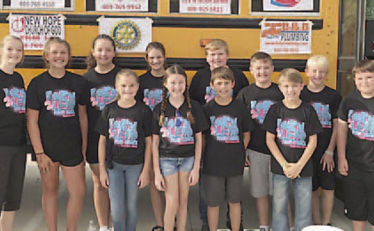 Before the Fill the Bus School Supply Collection Drive was postponed last Saturday morning, the Vidor Middle School Pirate Council posed for this picture in front of the big yellow school bus parked in the Walmart parking lot. But, grey clouds were forming and getting ready to open up with lightning and rain. Archive Photo
