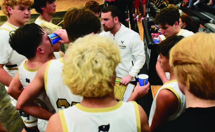 Varsity boys basketball coach Joseph Hoyt talks strategy during a timeout. File Photos
