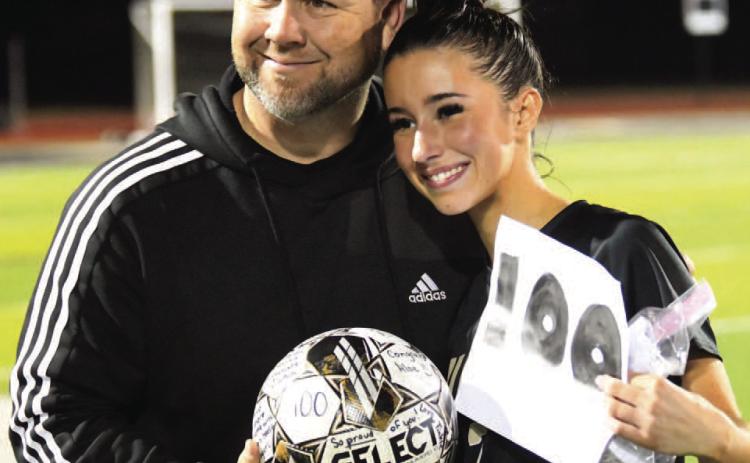 Vidor Head Girls Soccer Coach Ralph Fields poses with VHS senior Taylor Bull after she scored her 100th career goal last night versus Silsbee in this season’s first district game. “Taylor has been a dominant scoring threat for the Lady Pirates as she currently leads the team in scoring so far this season with 16 goals and she broke the school’s single season scoring record last year scoring 45 total goals,” Fields said.