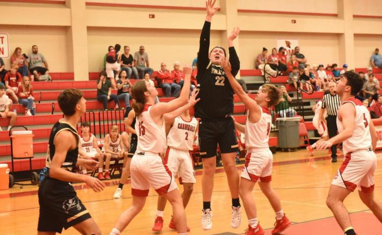 Dalton Cash, 6’4” Pirate senior, shoots and scores Friday in the Pirates district opener in Bridge City. Photo by Randall Luker