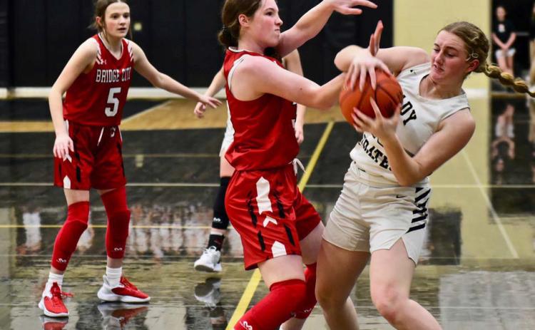 Natalie Morrison fights to retain possession of the ball versus Bridge City. Photo by Randall Luker