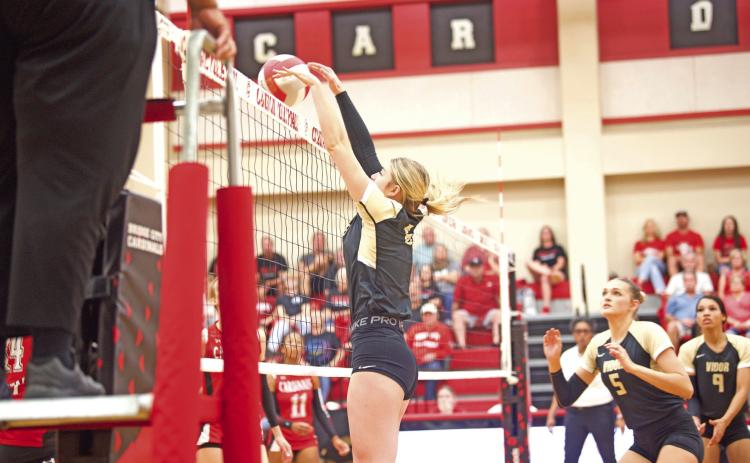 Madison Guillot blocks a BC return in Friday’s seed game in Bridge City.