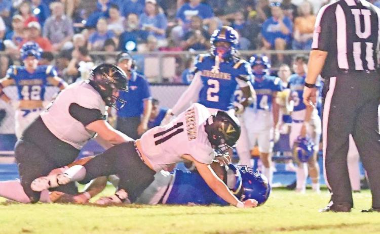 Brody Bloss, #11, and Owen Stephenson, #79, stop a H-F ball carrier Friday at Hamshire.