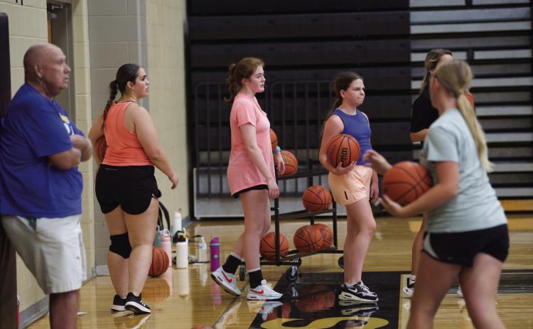Several Lady Pirates practiced their basketball skills Tuesday morning in the newly waxed Pirate Gym. The ladies practiced their passing and shooting from different positions on the court.