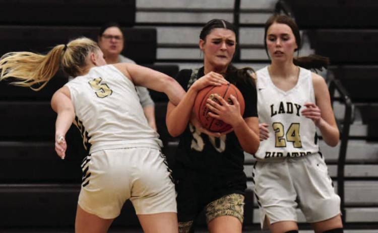 Lady Pirates Raegan Stephenson , left and Hailey Stelly, right, put the squeeze on a Lady Bear Tuesday in Pirate Gym. Photo by Randall Luker