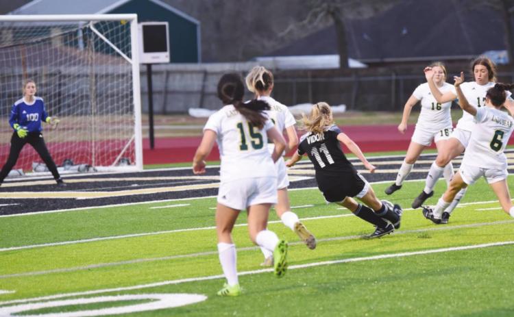 Vidor’s Brooklyn Healy sends her 100th career goal toward the net in Friday’s match with LCM.