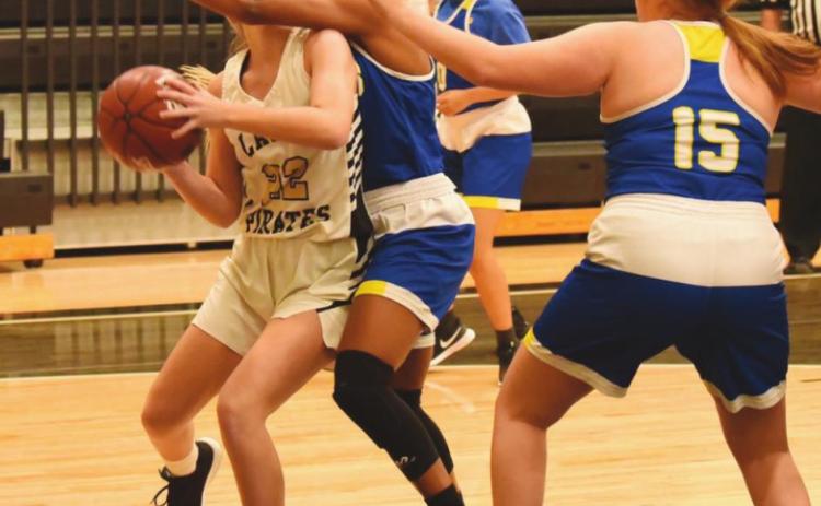 A well guarded Jaelyn Justice looks for a shot under the goal.