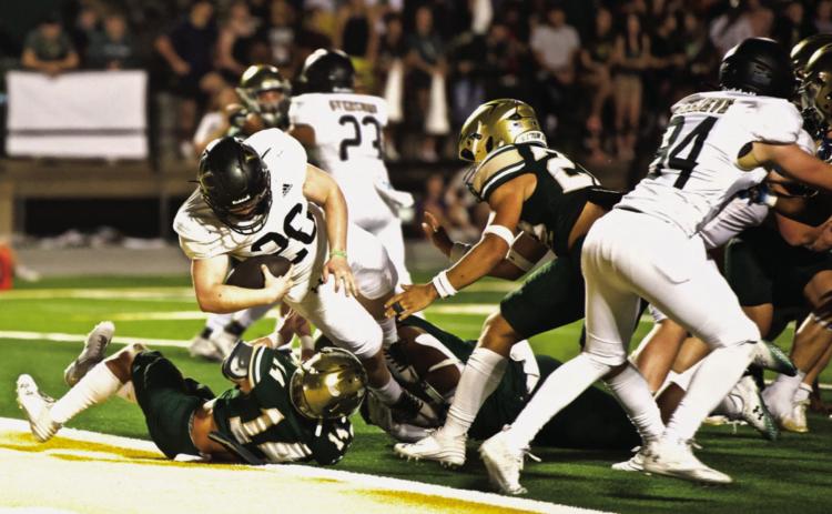 Pirate running back Riley Marlow runs over a Bear defender to score a touchdown Friday at LCM.