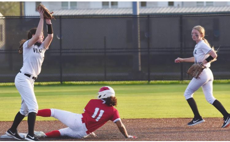 Lady Pirate shortstop Brilie Cornelison reaches for the throw as a Lady Cardinal slides into second base. Second baseman Gracie Matherne provides backup.