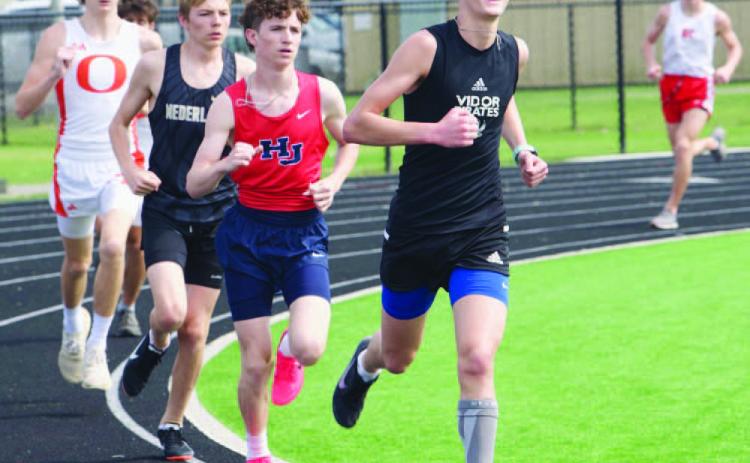 Branson Healy, front, placed 2nd in the 3200 meter run with time of 11:19.50 at the Bridge City relays Thursday. Photo by Randall Luker