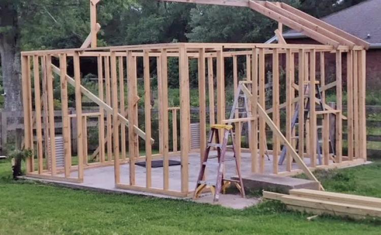 Framing the roof was challenging for us and required a good bit of energy, especially while climbing ladders, holding the lumber into position, manipulating screws and drills to secure the boards into place (image courtesy: John Green).
