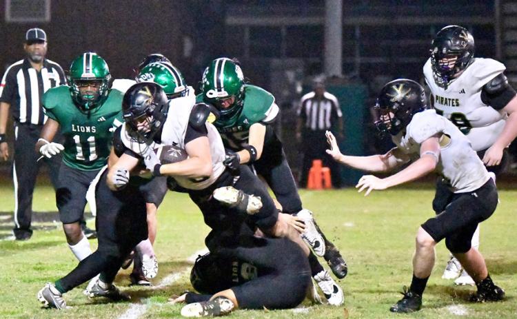 Brody Bloss fights through several Lion defenders to score.