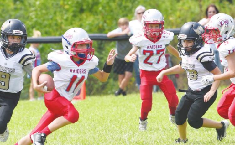 Junior White defenders #9 Karaon Cudd and #18 Carlos Gutierrez pressure the Lumberton QB in Saturday action.