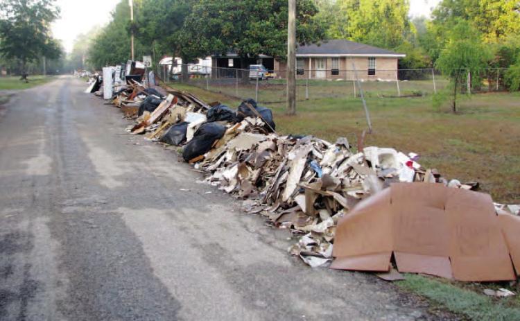 After paying with more than $10 million in local tax dollars for Hurricane Harvey Storm Debris removal for the last ten months, FEMA has agreed to reimburse Orange County soon for its efforts to pick up debris piles like this one in Pine Forest. Archive Photo