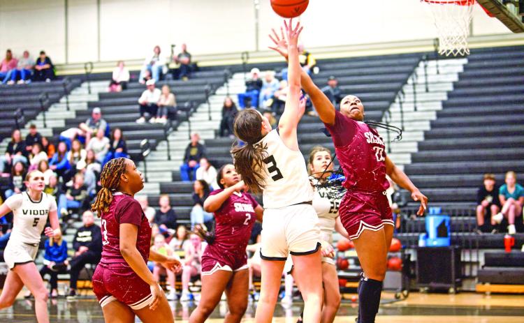 Allie Williams shoots A Silsbee defender swats at the ball as Vidor’s Allie Williams shoots from the paint Friday in Pirate Gym.