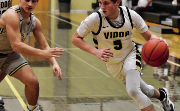 Bryce Loftin drives on the basket in Friday district game versus LCM. Photo by Randall Luker