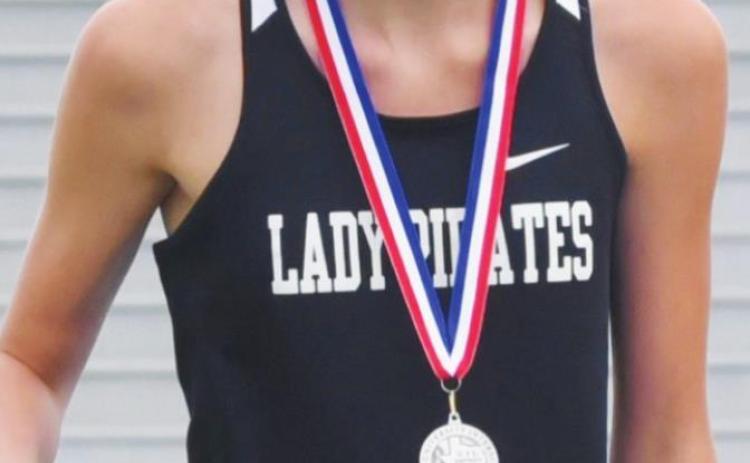 Jaden Lee smiles after receiving her medal for 2nd place in 100M hurdles.