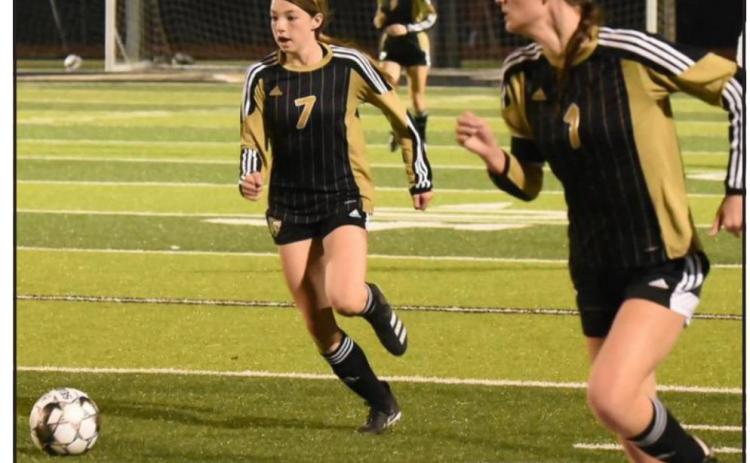Lady Pirates Chloe Post, #7, and Jaden Lee, #1, team up to move the ball into scoring position versus Cleveland. Photo by Randall Luker