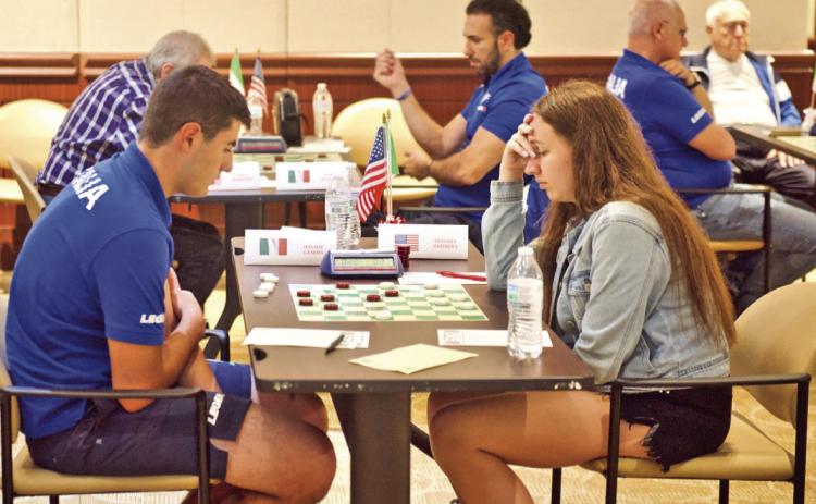 Team USA’s Tetiana Zaitseva and Team Italy’s Davide Gemma concentrate on the playing board during their match Tuesday at Vidor City Hall.